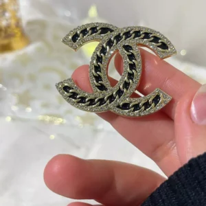 black channel brooch