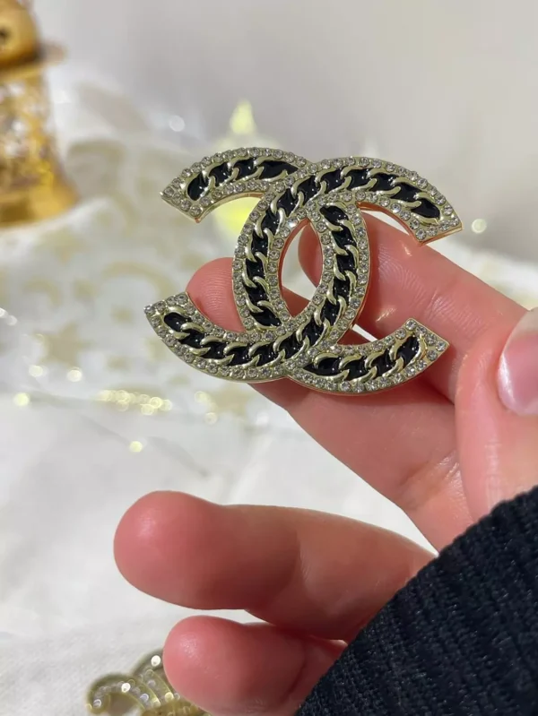 black channel brooch